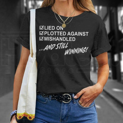 "Lied On, Plotted Against, Still Winning" Unisex T-Shirt – Resilience Graphic Tee